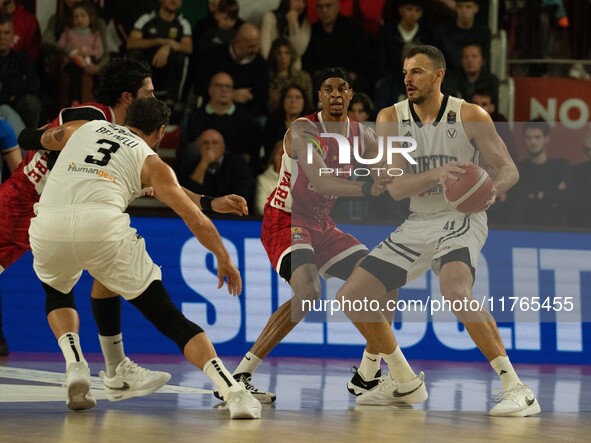 Ante Zizic of Virtus Bologna and Kaodirichi Akobundu-Ehiogu of Openjobmetis Varese compete during the LBA Italy Championship match between O...