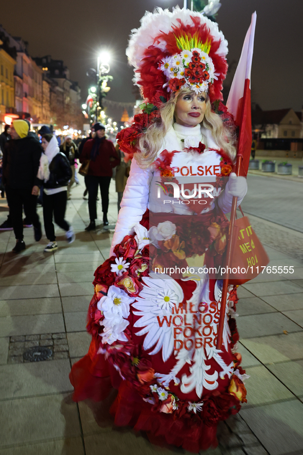 A person dressed in Polish symbols walks the street ahead of the Poland Independence Day in Warsaw, Poland on November 10, 2024. 