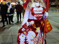 A person dressed in Polish symbols walks the street ahead of the Poland Independence Day in Warsaw, Poland on November 10, 2024. (