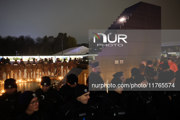 Police officers stand near the Smolensk plane disaster memorial a day ahead of the Poland Independence Day in Warsaw, Poland on November 10,...