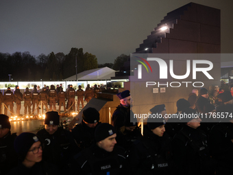 Police officers stand near the Smolensk plane disaster memorial a day ahead of the Poland Independence Day in Warsaw, Poland on November 10,...