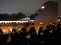 Police officers stand near the Smolensk plane disaster memorial a day ahead of the Poland Independence Day in Warsaw, Poland on November 10,...