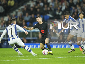 Robert Lewandowski centre-forward of Barcelona and Poland surrounded by Real Sociedad players during the LaLiga match between Real Sociedad...