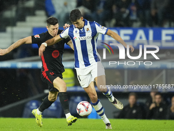 Robert Lewandowski centre-forward of Barcelona and Poland and Nayef Aguerd centre-back of Real Sociedad and Morocco compete for the ball dur...