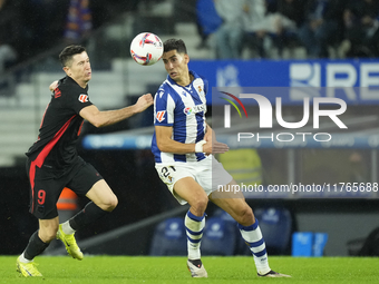 Robert Lewandowski centre-forward of Barcelona and Poland and Nayef Aguerd centre-back of Real Sociedad and Morocco compete for the ball dur...