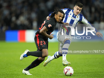 Jules Kounde centre-back of Barcelona and France and Ander Barrenetxea left winger of Real Sociedad and Spain compete for the ball during th...