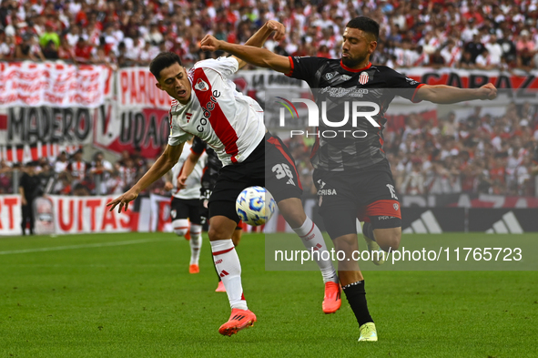 Pablo Solari of River Plate competes for the ball against Nicolas Demartini of Barracas Central during a Liga Profesional 2024 match between...