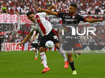 Pablo Solari of River Plate competes for the ball against Nicolas Demartini of Barracas Central during a Liga Profesional 2024 match between...