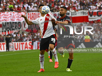 Pablo Solari of River Plate competes for the ball against Nicolas Demartini of Barracas Central during a Liga Profesional 2024 match between...