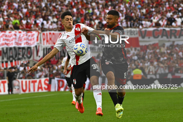 Pablo Solari of River Plate competes for the ball against Nicolas Demartini of Barracas Central during a Liga Profesional 2024 match between...