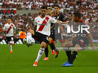 Santiago Simon of River Plate competes for the ball against Maximiliano Puig of Barracas Central during a Liga Profesional 2024 match betwee...