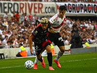 Pablo Solari of River Plate competes for the ball against Rodrigo Insua of Barracas Central during a Liga Profesional 2024 match between Riv...