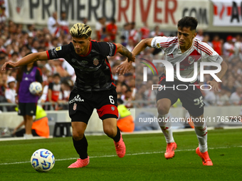 Pablo Solari of River Plate competes for the ball against Rodrigo Insua of Barracas Central during a Liga Profesional 2024 match between Riv...