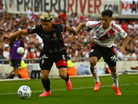 Pablo Solari of River Plate competes for the ball against Rodrigo Insua of Barracas Central during a Liga Profesional 2024 match between Riv...