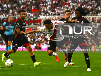 Pablo Solari of River Plate competes for the ball against Carlos Sanchez of Barracas Central during a Liga Profesional 2024 match between Ri...