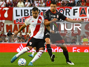 Leandro Gonzalez Pirez of River Plate competes for the ball against Nicolas Caparro of Barracas Central during a Liga Profesional 2024 match...