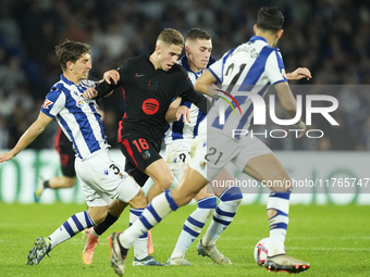 Fermin Lopez central midfield of Barcelona and Spain surrounded by Real Sociedad players during the LaLiga match between Real Sociedad and F...