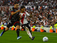 Milton Casco of River Plate competes for the ball against Maximiliano Puig of Barracas Central during a Liga Profesional 2024 match between...