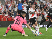 Marcelo Mino of Barracas Central saves Franco Mastantuono's shot during the match between River Plate and Barracas Central at Estadio Mas Mo...