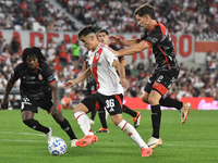 Pablo Solari of River Plate and Carlos Sanchez and Nicolas Carparo of Barracas Central are present during the match between River Plate and...