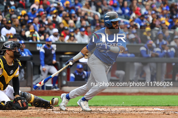 Emilio Bonifacio #64 of Los Tigres del Licey singles during the third inning of a baseball game against Las Aguilas Cibaenas at Citi Field i...