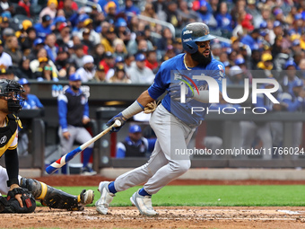 Emilio Bonifacio #64 of Los Tigres del Licey singles during the third inning of a baseball game against Las Aguilas Cibaenas at Citi Field i...