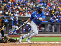 Emilio Bonifacio #64 of Los Tigres del Licey singles during the third inning of a baseball game against Las Aguilas Cibaenas at Citi Field i...