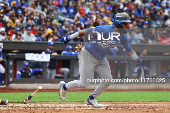 Emilio Bonifacio #64 of Los Tigres del Licey singles during the third inning of a baseball game against Las Aguilas Cibaenas at Citi Field i...