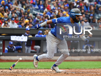 Emilio Bonifacio #64 of Los Tigres del Licey singles during the third inning of a baseball game against Las Aguilas Cibaenas at Citi Field i...