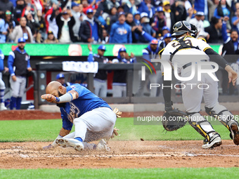 Emilio Bonifacio #64 of Los Tigres del Licey scores during the third inning of a baseball game against Las Aguilas Cibaenas at Citi Field in...