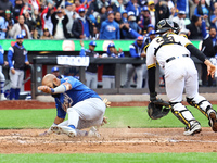 Emilio Bonifacio #64 of Los Tigres del Licey scores during the third inning of a baseball game against Las Aguilas Cibaenas at Citi Field in...