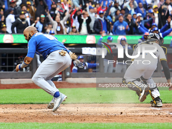 Emilio Bonifacio #64 of Los Tigres del Licey scores during the third inning of a baseball game against Las Aguilas Cibaenas at Citi Field in...