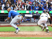 Emilio Bonifacio #64 of Los Tigres del Licey scores during the third inning of a baseball game against Las Aguilas Cibaenas at Citi Field in...