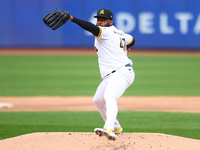 Las Aguilas Cibaenas starting pitcher Johnny Cueto #47 throws during the first inning of a baseball game against Los Tigres del Licey at Cit...