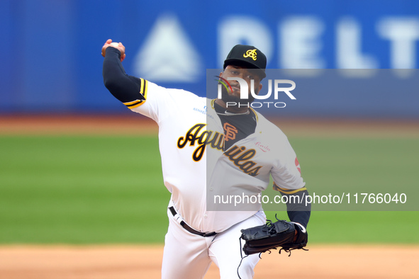 Las Aguilas Cibaenas starting pitcher Johnny Cueto #47 throws during the first inning of a baseball game against Los Tigres del Licey at Cit...