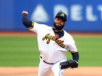 Las Aguilas Cibaenas starting pitcher Johnny Cueto #47 throws during the first inning of a baseball game against Los Tigres del Licey at Cit...