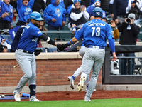 Logan Davidson #73 of Los Tigres del Licey is congratulated after scoring during the third inning of a baseball game against Las Aguilas Cib...