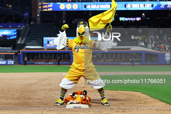 The Las Aguilas Cibaenas mascot celebrates with a stuffed tiger after the team's 3-2 win in the baseball game against Los Tigres del Licey a...