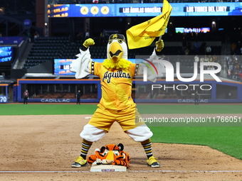 The Las Aguilas Cibaenas mascot celebrates with a stuffed tiger after the team's 3-2 win in the baseball game against Los Tigres del Licey a...