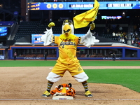 The Las Aguilas Cibaenas mascot celebrates with a stuffed tiger after the team's 3-2 win in the baseball game against Los Tigres del Licey a...