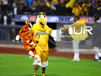 The Las Aguilas Cibaenas mascot celebrates with a stuffed tiger after the team's 3-2 win in the baseball game against Los Tigres del Licey a...