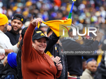 The Las Aguilas Cibaenas fans cheer during the baseball game against the Los Tigres del Licey at Citi Field in Corona, N.Y., on November 10,...