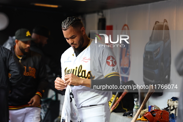 Las Aguilas Cibaenas pitcher Dinelson Lamet #71 stands in the dugout during the third inning of a baseball game against Los Tigres del Licey...