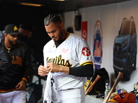 Las Aguilas Cibaenas pitcher Dinelson Lamet #71 stands in the dugout during the third inning of a baseball game against Los Tigres del Licey...