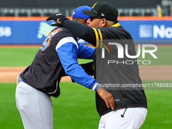 Los Tigres del Licey manager Gilbert Gomez greets Las Aguilas Cibaenas manager Yadier Molina before the baseball game against Las Aguilas Ci...