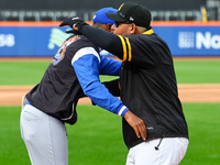 Los Tigres del Licey manager Gilbert Gomez greets Las Aguilas Cibaenas manager Yadier Molina before the baseball game against Las Aguilas Ci...