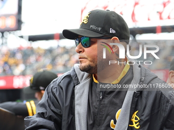 Las Aguilas Cibaenas manager Yadier Molina #11 stands in the dugout during the baseball game against Los Tigres del Licey at Citi Field in C...