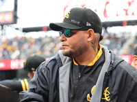 Las Aguilas Cibaenas manager Yadier Molina #11 stands in the dugout during the baseball game against Los Tigres del Licey at Citi Field in C...