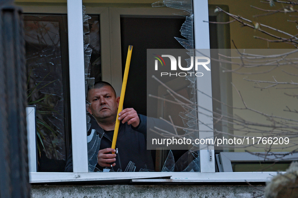 A man stands on the balcony of a residential building damaged by the Russian drone attack in the Khadzhybeiskyi district of Odesa, southern...