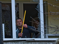 A man stands on the balcony of a residential building damaged by the Russian drone attack in the Khadzhybeiskyi district of Odesa, southern...